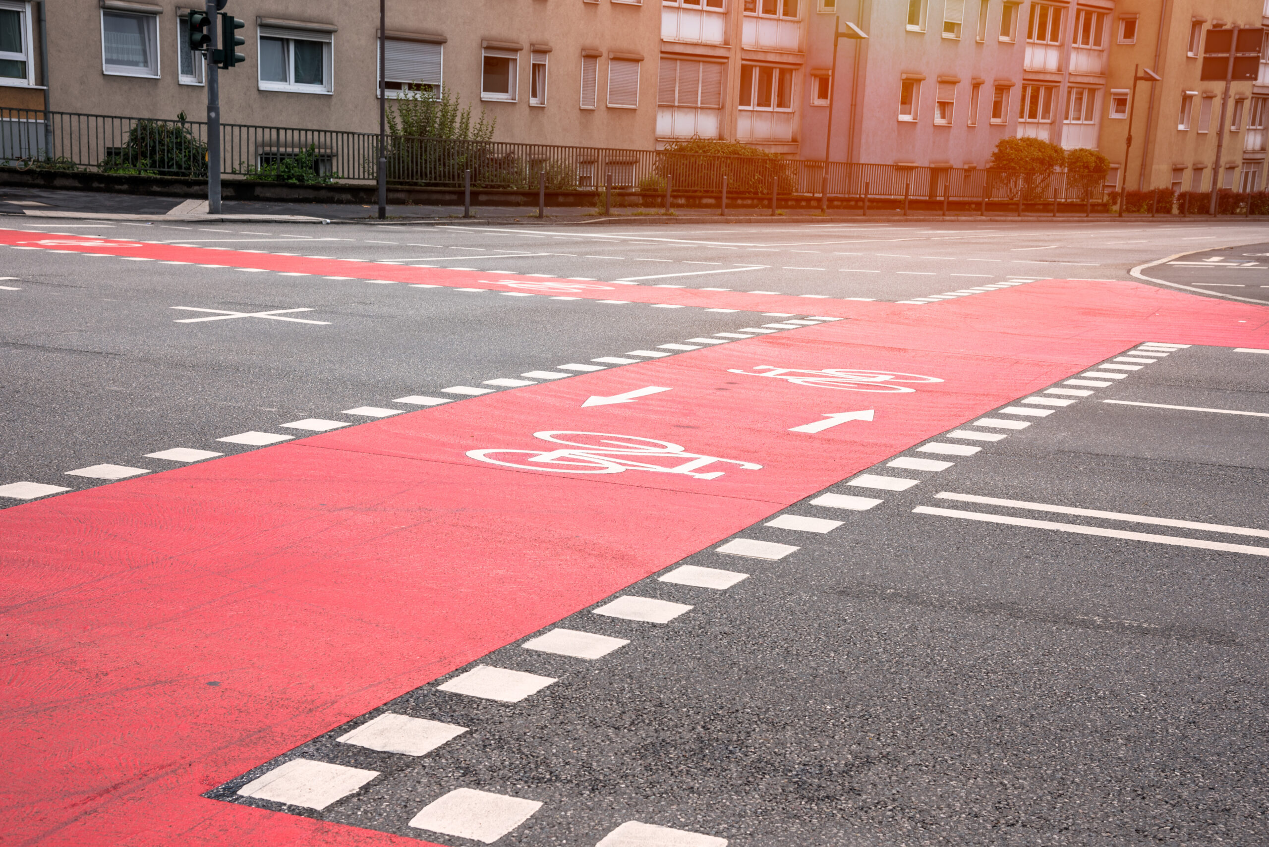 Empty bicycle lanes at crossroads in a residential district Straßenmarkierung mit Fahrradwegen